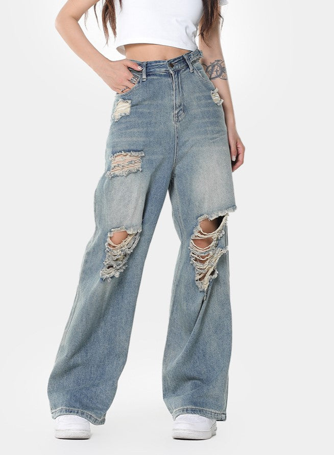 Blauwe vintage noodlijdende wijde pijpen gescheurde jeans